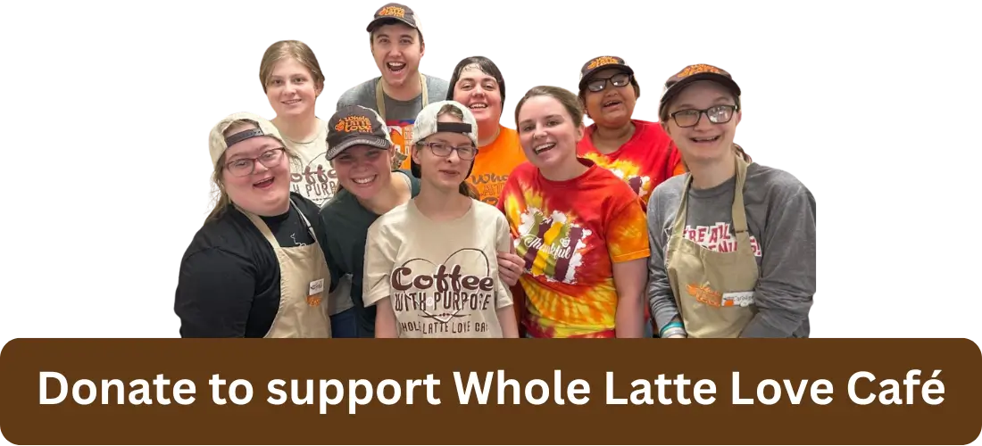 A group of smiling café staff wearing branded shirts and hats stand together; text reads, "Donate to support Whole Latte Love Café.